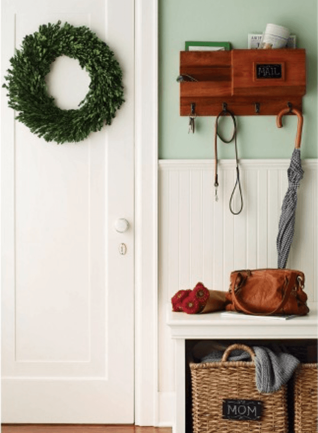 boxwood wreath hanging inside mudroom