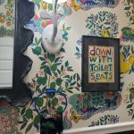 wallpapered bathroom with colorful touches