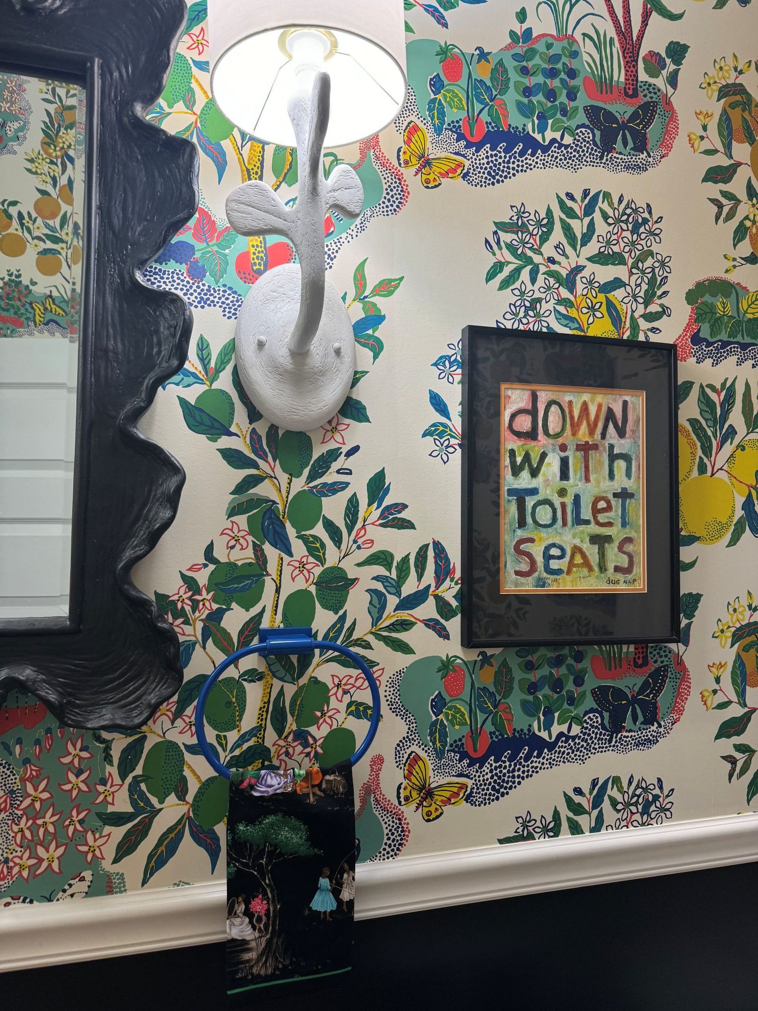 wallpapered bathroom with colorful touches